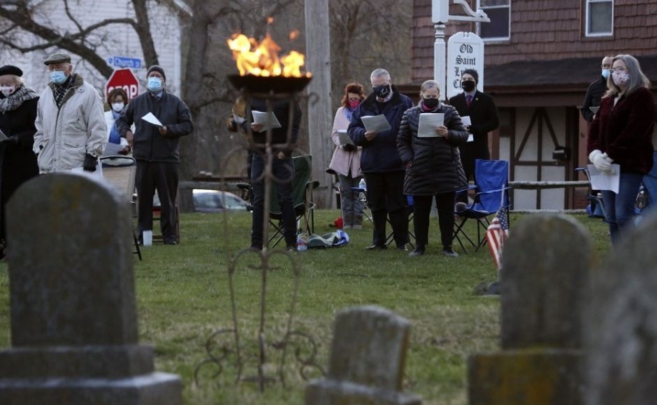 Parishioners of St Paul's Episcopal Church stand to worship during an Easter sunrise service held on the burial grounds outside of Old St Luke's Church in Carnegie, Pa. For many congregants, this was the first in-person worship service they have attended since the coronavirus surge in November. Photo via The Associated Press/Jessie Wardarski Parishioners of St Paul's Episcopal Church stand to worship during an Easter sunrise service held on the burial grounds outside of Old St Luke's Church in Carnegie, Pa. For many congregants, this was the first in-person worship service they have attended since the coronavirus surge in November. Photo via The Associated Press/Jessie Wardarski