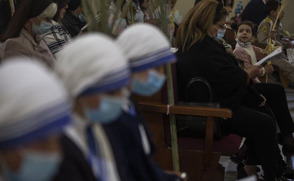 Christians take part in Palm Sunday Mass at the Roman Catholic Church of the Holy Family, in Gaza City, on Sunday, 28 March 2021. Photo by The Associated Press/Khalil Hamra Christians take part in Palm Sunday Mass at the Roman Catholic Church of the Holy Family, in Gaza City, on Sunday, 28 March 2021. Photo by The Associated Press/Khalil Hamra