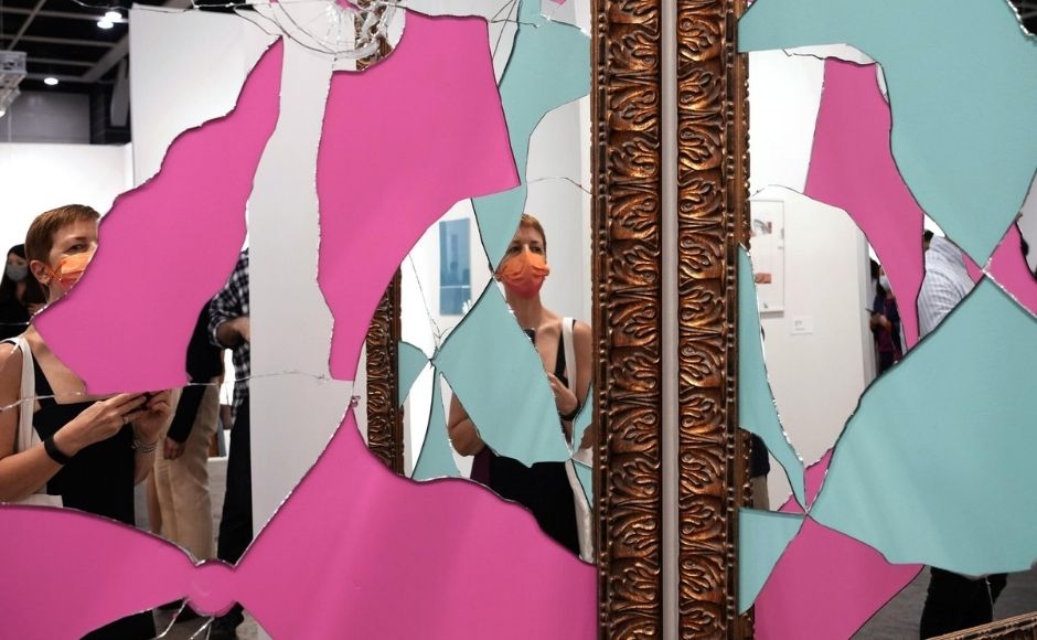 Art Basel Hong Kong, one of Asia’s premier art fairs, is back in slimmer form after a hiatus prompted by COVID-19. | In the picture: A visitor wearing a face mask takes a close look at an artwork "Two Less One coloured" created by Italian artist Michelangelo Pistoletto at Art Basel in Hong Kong. Photo via The Associated Press/Vincent Yu Art Basel Hong Kong, one of Asia’s premier art fairs, is back in slimmer form after a hiatus prompted by COVID-19. | In the picture: A visitor wearing a face mask takes a close look at an artwork "Two Less One coloured" created by Italian artist Michelangelo Pistoletto at Art Basel in Hong Kong. Photo via The Associated Press/Vincent Yu