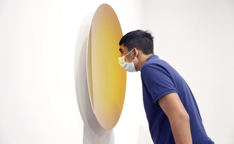 A visitor takes a close look at an artwork titled "Spanish Gold to Pagan Gold" created by British-Indian sculptor Anish Kapoor at Art Basel in Hong Kong. Photo via The Associated Press/Vincent Yu A visitor takes a close look at an artwork titled "Spanish Gold to Pagan Gold" created by British-Indian sculptor Anish Kapoor at Art Basel in Hong Kong. Photo via The Associated Press/Vincent Yu