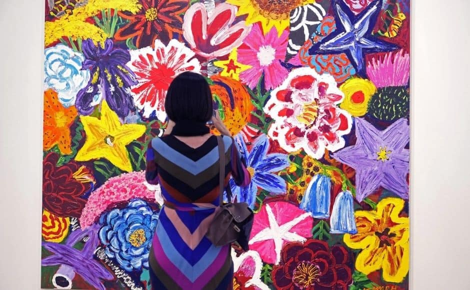 A visitor wearing a face mask takes a close look at an artwork "Untitled, 2018" created by Korean artist Kim Chong-Hak at Art Basel in Hong Kong. Photo via The Associated Press/Vincent Yu A visitor wearing a face mask takes a close look at an artwork "Untitled, 2018" created by Korean artist Kim Chong-Hak at Art Basel in Hong Kong. Photo via The Associated Press/Vincent Yu