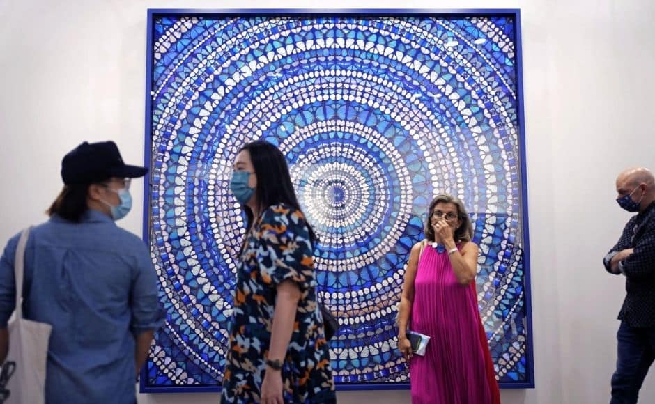A steady flow of visitors, all wearing masks, perused the works in a cavernous convention center while buyer representatives used smartphones on selfie sticks to zoom in on specific pieces for buyers overseas. | In the picture: Visitors pass an artwork titled "Martyr, 2019" created by British artist Damien Hirst at Art Basel in Hong Kong. Photo via The Associated Press/Vincent Yu A steady flow of visitors, all wearing masks, perused the works in a cavernous convention center while buyer representatives used smartphones on selfie sticks to zoom in on specific pieces for buyers overseas. | In the picture: Visitors pass an artwork titled "Martyr, 2019" created by British artist Damien Hirst at Art Basel in Hong Kong. Photo via The Associated Press/Vincent Yu