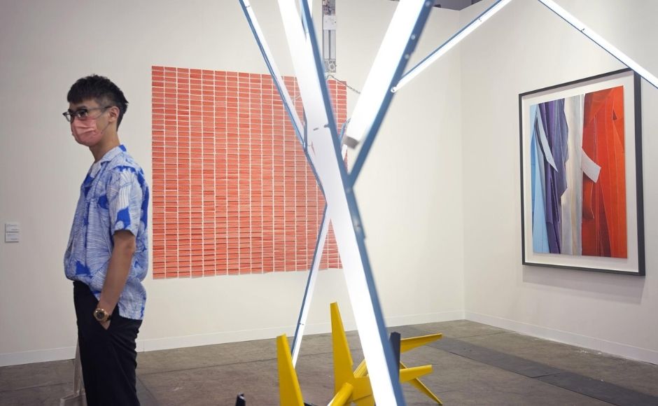 About 100 galleries from 23 countries are participating, half the pre-pandemic level, with others joining via online viewing rooms. The show runs through Sunday. | In the picture: A visitor stands next to "Skin, 2013" created by Brazilian artist Jac Leirner at Art Basel in Hong Kong. Photo via The Associated Press/Vincent Yu About 100 galleries from 23 countries are participating, half the pre-pandemic level, with others joining via online viewing rooms. The show runs through Sunday. | In the picture: A visitor stands next to "Skin, 2013" created by Brazilian artist Jac Leirner at Art Basel in Hong Kong. Photo via The Associated Press/Vincent Yu
