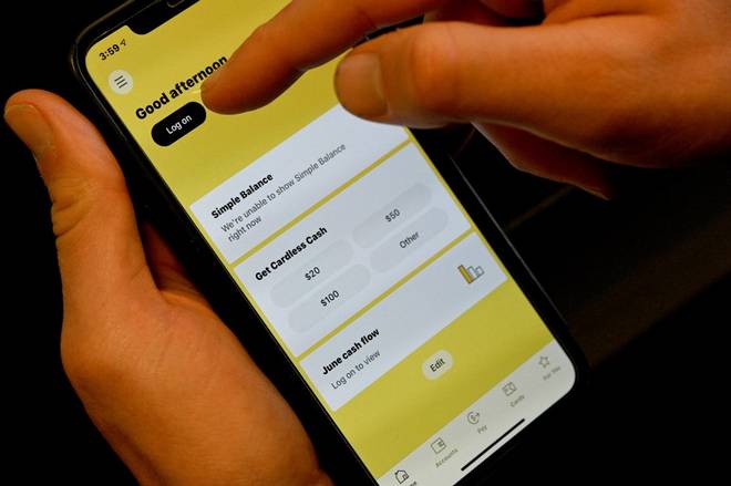 The image shows a person trying to log into his bank account through a mobile app in Sydney on June 17, 2021, as country's major banks reported online outages affecting their websites and apps. Image: AFP