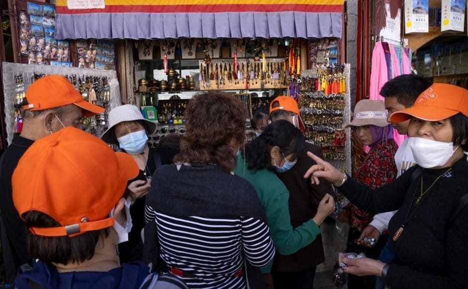 “The biggest challenge for us is the contradiction between the protection and usage of the cultural relics,” Tashi told journalists in Lhasa, the Tibetan capital. He spoke during a government-organised tour that gave foreign journalists rare access to Tibet, but under the watchful eye of officials who set the agenda. | In the picture: Members of a Chinese tour group shop at a souvenir shop outside of the Jokhang Temple in Lhasa in western China's Tibet Autonomous Region, on Tuesday, 1 June, 2021. Photo via The Associated Press/Mark Schiefelbein “The biggest challenge for us is the contradiction between the protection and usage of the cultural relics,” Tashi told journalists in Lhasa, the Tibetan capital. He spoke during a government-organised tour that gave foreign journalists rare access to Tibet, but under the watchful eye of officials who set the agenda. | In the picture: Members of a Chinese tour group shop at a souvenir shop outside of the Jokhang Temple in Lhasa in western China's Tibet Autonomous Region, on Tuesday, 1 June, 2021. Photo via The Associated Press/Mark Schiefelbein