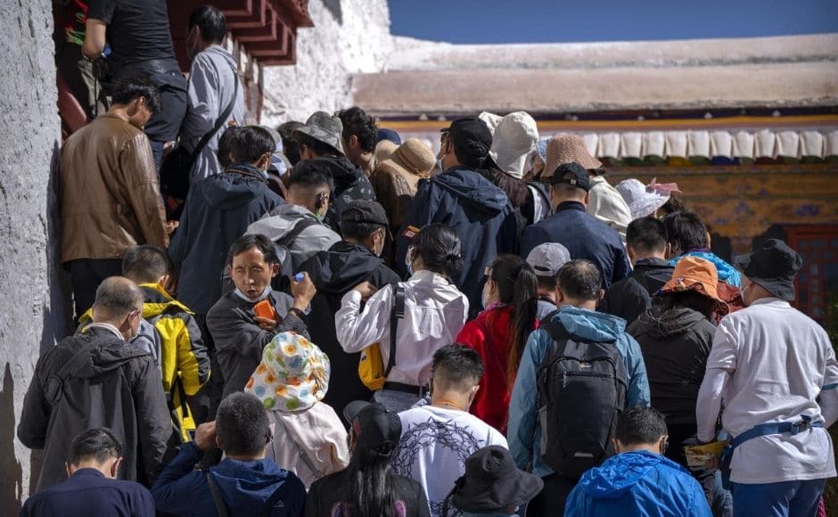The growing numbers of tourists appear unconcerned by political controversies long circling Tibet. China’s communist forces entered the region in 1951, and the Dalai Lama, Tibet’s traditional spiritual and political leader, fled to India during an abortive uprising against Chinese rule in 1959. | In the picture: Tourists wait to climb steps to an interior area at the Potala Palace in Lhasa in western China's Tibet Autonomous Region, on Tuesday, 1 June, 2021. Photo via The Associated Press/Mark Schiefelbein The growing numbers of tourists appear unconcerned by political controversies long circling Tibet. China’s communist forces entered the region in 1951, and the Dalai Lama, Tibet’s traditional spiritual and political leader, fled to India during an abortive uprising against Chinese rule in 1959. | In the picture: Tourists wait to climb steps to an interior area at the Potala Palace in Lhasa in western China's Tibet Autonomous Region, on Tuesday, 1 June, 2021. Photo via The Associated Press/Mark Schiefelbein