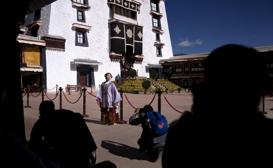 Tibet has shifted its focus from international to domestic visitors as China’s middle class has grown, said Emily Yeh, a professor of geography at the University of Colorado Boulder. Tibetans have at times complained about Chinese tourists disrespecting cultural traditions, including stepping on prayer flags, she said. | In the picture: A Chinese tourist in Tibetan dress poses for a photo in a courtyard at the Potala Palace in Lhasa in western China's Tibet Autonomous Region, on Tuesday, 1 June, 2021. Photo via The Associated Press/Mark Schiefelbein Tibet has shifted its focus from international to domestic visitors as China’s middle class has grown, said Emily Yeh, a professor of geography at the University of Colorado Boulder. Tibetans have at times complained about Chinese tourists disrespecting cultural traditions, including stepping on prayer flags, she said. | In the picture: A Chinese tourist in Tibetan dress poses for a photo in a courtyard at the Potala Palace in Lhasa in western China's Tibet Autonomous Region, on Tuesday, 1 June, 2021. Photo via The Associated Press/Mark Schiefelbein