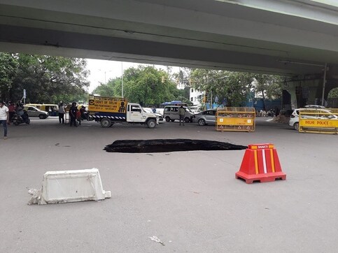 Portion of road under IIT-Delhi flyover caves in after heavy rains; traffic diverted Portion of road under IIT-Delhi flyover caves in after heavy rains; traffic diverted
