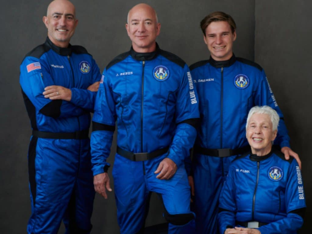 Mark Bezos, Jeff Bezos, Oliver Daemon and Wally Funk pose in their bright blue flight suits. Image credit: Twitter/ @blueorigin 