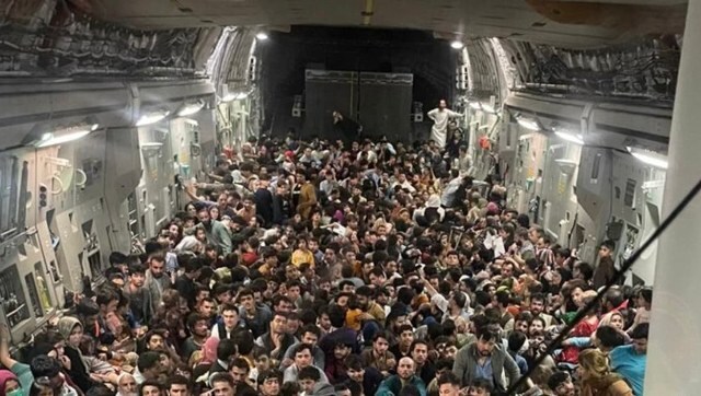 Striking photo of Aghans crammed into flight surfaces as US military officials question evacuation pace