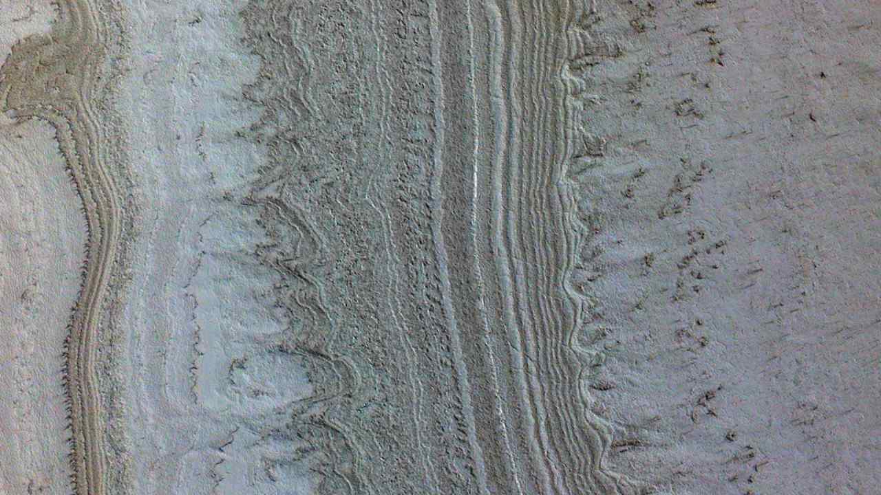This image taken by NASA’s Mars Reconnaissance Orbiter shows ice sheets at Mars’ south pole. The spacecraft detected clays nearby this ice; scientists have proposed such clays are the source of radar reflections that have been previously interpreted as liquid water. Image Credits: NASA/JPL-Caltech/University of Arizona/JHU