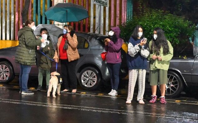 Videos shared on Twitter showed people screaming and tightly hugging each other on the sidewalk as car alarms go off, trees shake and exploding transformers light the sky blue. AFP Videos shared on Twitter showed people screaming and tightly hugging each other on the sidewalk as car alarms go off, trees shake and exploding transformers light the sky blue. AFP