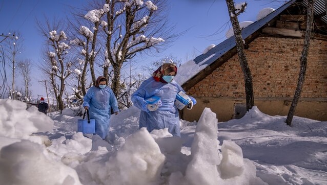 Kashmir: Vaccine workers trek in Srinagar's snowy mountains Kashmir: Vaccine workers trek in Srinagar's snowy mountains