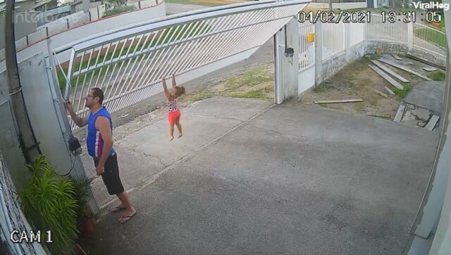 Watch: Little girl with 'vice-like grip' clings to gate as it rises; here's how users reacted to hilarious clip Watch: Little girl with 'vice-like grip' clings to gate as it rises; here's how users reacted to hilarious clip