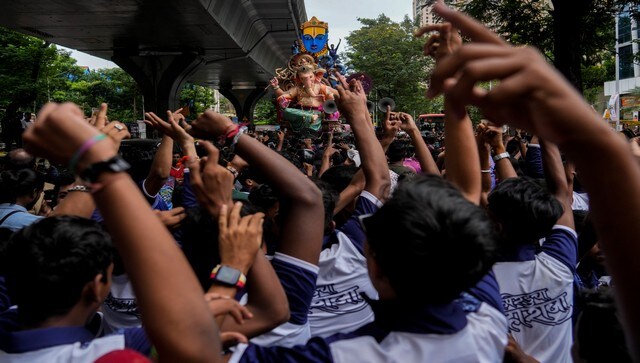 People cheer during a procession in Mumbai. Ganesh Chaturthi is celebrated across India wherein Ganesh idols are brought into homes or pandals and the festivities go on for 10 days. AP People cheer during a procession in Mumbai. Ganesh Chaturthi is celebrated across India wherein Ganesh idols are brought into homes or pandals and the festivities go on for 10 days. AP