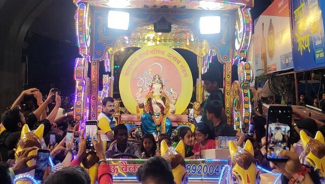 People gather around Ganesh Galli's Mumbaicha Raja which was unveiled on Saturday. Located just a few lanes away from Lalbaugcha Raja, Mumbaicha Raja is as popular as the former. Found in 1928, the Mandal will be celebrating its 95th Ganeshotsav this year. Known for recreating famous places in India, this year the pandal will be a replica of the Kashi Vishwanath temple. Image Courtesy: Lalbaug Sarvajanik Utsav Mandal People gather around Ganesh Galli's Mumbaicha Raja which was unveiled on Saturday. Located just a few lanes away from Lalbaugcha Raja, Mumbaicha Raja is as popular as the former. Found in 1928, the Mandal will be celebrating its 95th Ganeshotsav this year. Known for recreating famous places in India, this year the pandal will be a replica of the Kashi Vishwanath temple. Image Courtesy: Lalbaug Sarvajanik Utsav Mandal