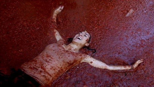 A woman covered in tomato pulp lies on a tomato-flooded street in Bunol. The origins of the festival go back to 1944 when a few locals engaged in a dispute during a parade and threw tomatoes at each other. Following this, people decided to repeat the food fight. It is celebrated in the last week of August every year. AFP A woman covered in tomato pulp lies on a tomato-flooded street in Bunol. The origins of the festival go back to 1944 when a few locals engaged in a dispute during a parade and threw tomatoes at each other. Following this, people decided to repeat the food fight. It is celebrated in the last week of August every year. AFP