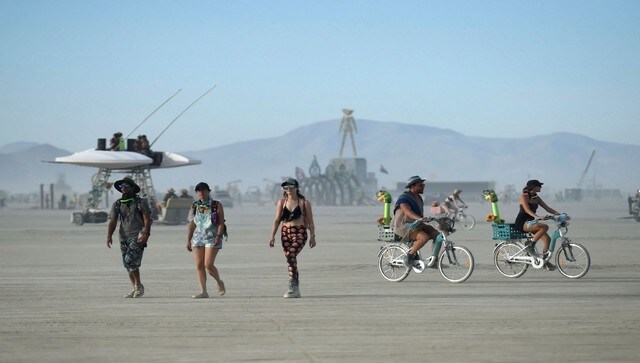 People walk and ride their bikes in the Black Rock desert in Nevada, the festival’s official location. This year, celebrations were clouded by a dust storm that plummeted visibility. The theme for this year was ‘Waking Dream’. AP People walk and ride their bikes in the Black Rock desert in Nevada, the festival’s official location. This year, celebrations were clouded by a dust storm that plummeted visibility. The theme for this year was ‘Waking Dream’. AP