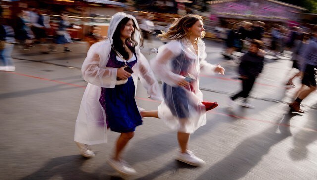 Visitors run onto the festival ground on the opening day of the 187th Oktoberfest beer festival. The first beer festival took place in 1810 and it has seen over 26 cancellations due to wars and the pandemic. AP Visitors run onto the festival ground on the opening day of the 187th Oktoberfest beer festival. The first beer festival took place in 1810 and it has seen over 26 cancellations due to wars and the pandemic. AP