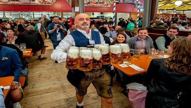 A waiter carries beer in one of the beer tents as revellers eagerly wait. Oktoberfest is the largest folk festival in Germany. Covering an area of 34.5 hectares, organisers expect to receive millions of people from all around the world. Apart from the obvious beverage, beer, fried sausages and pork knuckles are the specialties of the festival. AP A waiter carries beer in one of the beer tents as revellers eagerly wait. Oktoberfest is the largest folk festival in Germany. Covering an area of 34.5 hectares, organisers expect to receive millions of people from all around the world. Apart from the obvious beverage, beer, fried sausages and pork knuckles are the specialties of the festival. AP