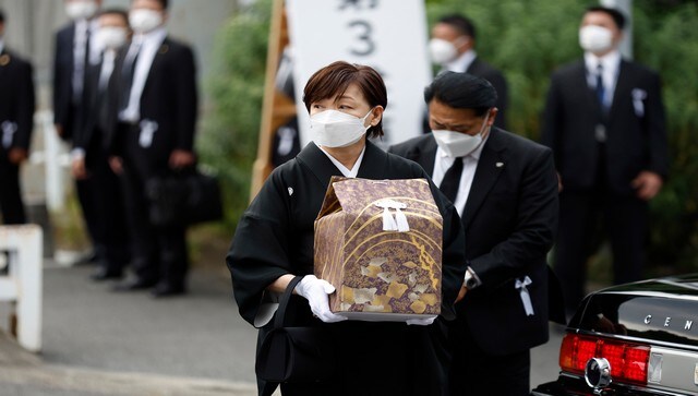 Akie Abe, the wife of former Prime Minister Shinzo Abe, carries a cinerary urn as she arrives at the state of the funeral of her husband. More than 4,000 people, including many Japanese lawmakers, attended the event. AP Akie Abe, the wife of former Prime Minister Shinzo Abe, carries a cinerary urn as she arrives at the state of the funeral of her husband. More than 4,000 people, including many Japanese lawmakers, attended the event. AP
