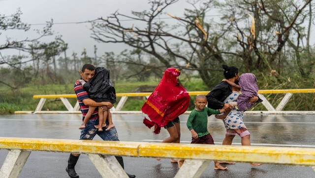 A family walks in the rain after Hurricane Ian hit Pinar del Rio, Cuba. The Hurricane is now heading toward Florida. AP A family walks in the rain after Hurricane Ian hit Pinar del Rio, Cuba. The Hurricane is now heading toward Florida. AP