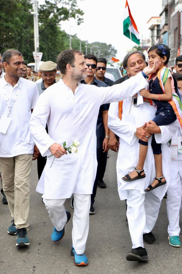 Congress leaders Rahul Gandhi and Shashi Tharoor greet a child as they walk through the streets of Kerala during the Bharat Jodo Yatra. As the yatra entered its second day, the turnout of people was impressive as supporters lined up in the streets to welcome and extend their support to Rahul Gandhi. Image courtesy: @INCIndia/Twitter Congress leaders Rahul Gandhi and Shashi Tharoor greet a child as they walk through the streets of Kerala during the Bharat Jodo Yatra. As the yatra entered its second day, the turnout of people was impressive as supporters lined up in the streets to welcome and extend their support to Rahul Gandhi. Image courtesy: @INCIndia/Twitter