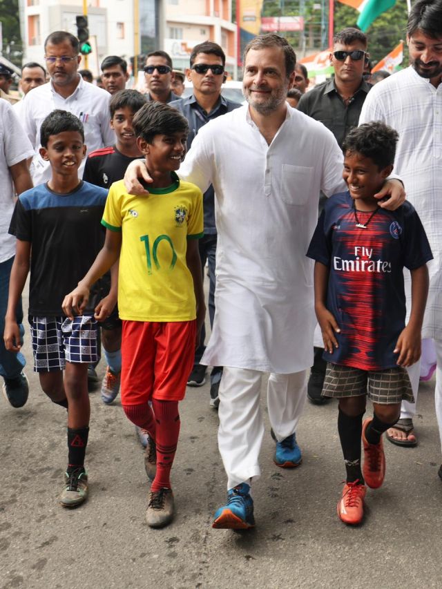Rahul Gandhi interacts with two young boys during a rally in Kerala. On Saturday, Union Home Minister Amit Shah took a jibe at Rahul Gandhi saying “he was out to unite the country wearing a costly foreign T-shirt.” Image courtesy: @INCIndia/Twitter Rahul Gandhi interacts with two young boys during a rally in Kerala. On Saturday, Union Home Minister Amit Shah took a jibe at Rahul Gandhi saying “he was out to unite the country wearing a costly foreign T-shirt.” Image courtesy: @INCIndia/Twitter