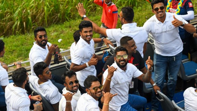 Sri Lankan players enjoy themselves during the open-top bus trophy parade in Colombo. AFP