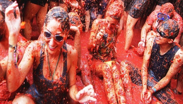 A woman wears goggles to protect her eyes from the pulp. Image courtesy: La Tomatina Festival A woman wears goggles to protect her eyes from the pulp. Image courtesy: La Tomatina Festival