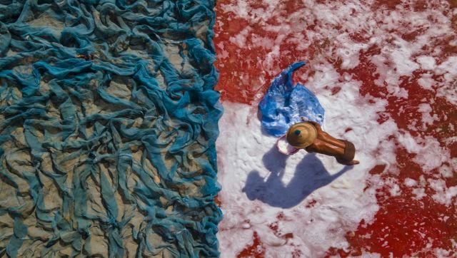 Washing Time: A man by himself is busy washing a huge number of fishing nets. The picture is perfectly divided in two: on the left side we can see a mass of dirty and dusty blue nets; whilst on the right side, on a reddish floor, the man is washing the nets with plenty of soap under the scorching sun. Image Courtesy: Myo Thet Washing Time: A man by himself is busy washing a huge number of fishing nets. The picture is perfectly divided in two: on the left side we can see a mass of dirty and dusty blue nets; whilst on the right side, on a reddish floor, the man is washing the nets with plenty of soap under the scorching sun. Image Courtesy: Myo Thet