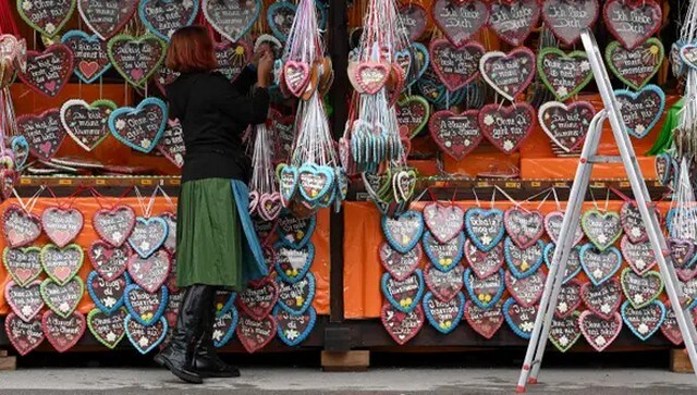 A vendor hangs up gingerbread hearts at her booth at the Oktoberfest. The beer festival features shops, rides and a wide range of delicacies. AFP A vendor hangs up gingerbread hearts at her booth at the Oktoberfest. The beer festival features shops, rides and a wide range of delicacies. AFP