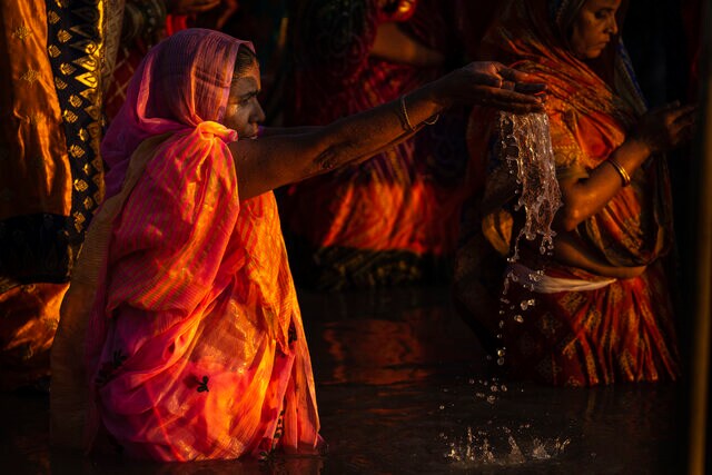 Hindu devotees gather by the river Brahmaputra and offer prayers in Guwahati, Assam, India, 30 October 2022. AP Hindu devotees gather by the river Brahmaputra and offer prayers in Guwahati, Assam, India, 30 October 2022. AP