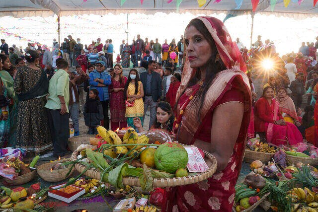 A Nepalese woman gets ready to offer prayers to the setting Sun at the Bagmati River during the Chhath Puja in Kathmandu, Nepal, 30 October 2022. AP A Nepalese woman gets ready to offer prayers to the setting Sun at the Bagmati River during the Chhath Puja in Kathmandu, Nepal, 30 October 2022. AP