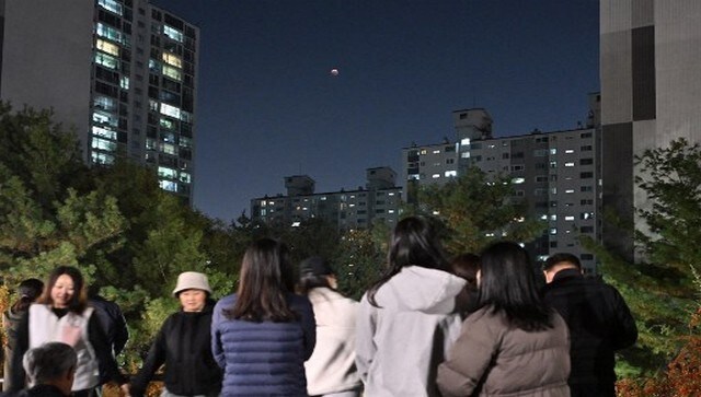 People in Seoul watch a blood moon during a total lunar eclipse. AFP People in Seoul watch a blood moon during a total lunar eclipse. AFP