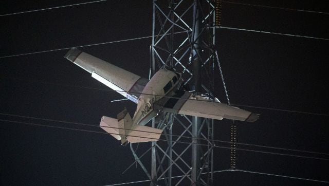 Crews work to rescue two in single-engine plane caught high in live power lines