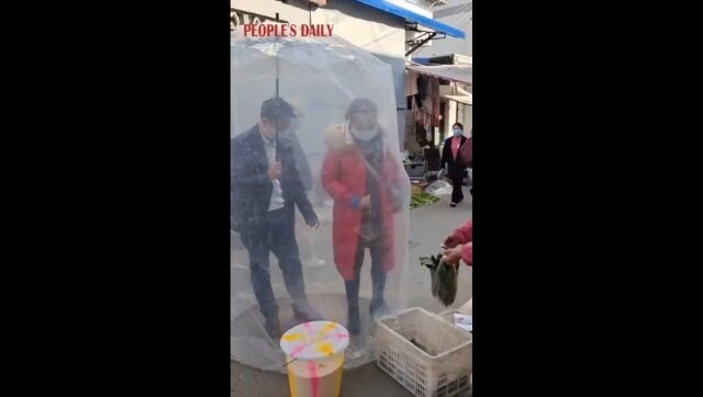 WATCH: Amid COVID crisis, Chinese couple uses 'unique' plastic cover to shield their body during shopping