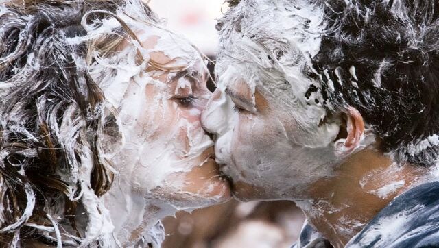 In a Right Lather: First year students of the University of St. Andrews, kiss as they take part in the annual “Raisin Monday Shaving Foam Fight” at the Lower College Lawn, in St. Andrews, eastern Scotland, on 17 October. The Raisin Monday Costumed Foam Fight is the culmination of a week of mentoring to welcome first year students into the “academic families” as they start their studies at the university. AFP In a Right Lather: First year students of the University of St. Andrews, kiss as they take part in the annual “Raisin Monday Shaving Foam Fight” at the Lower College Lawn, in St. Andrews, eastern Scotland, on 17 October. The Raisin Monday Costumed Foam Fight is the culmination of a week of mentoring to welcome first year students into the “academic families” as they start their studies at the university. AFP
