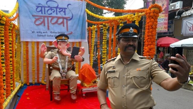 Bappa with a Twist: Policeman Rajendra Kane takes a selfie with an idol of Lord Ganesh in the avatar of a policeman during ‘Ganesh Chaturthi’ festival in Mumbai on 31 August. AFP Bappa with a Twist: Policeman Rajendra Kane takes a selfie with an idol of Lord Ganesh in the avatar of a policeman during ‘Ganesh Chaturthi’ festival in Mumbai on 31 August. AFP