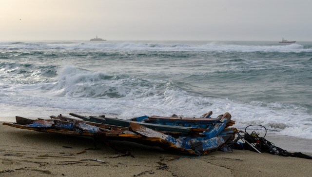 A wooden boat crowded with migrants smashed into rocky reefs and broke apart before dawn on Sunday off the Italian coast, authorities said. Rescuers recovered nearly 60 bodies, and dozens more people were missing in the rough waters. AP