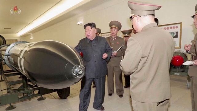 North Korea unveils new nuclear warheads as US air carrier arrives in South
