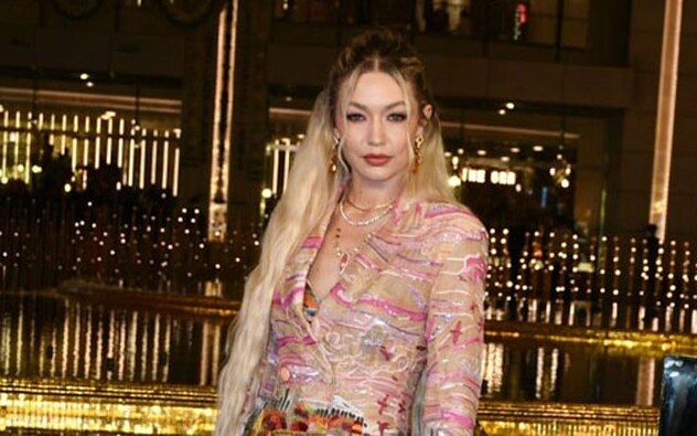 Hollywood star Gigi Hadid made a stunning entry. She wore a three-piece floral set. The ensemble consisted of a multi-colored bralette, a sheer long jacket, and flared pants, accessorized with delicate neck chains. Hollywood star Gigi Hadid made a stunning entry. She wore a three-piece floral set. The ensemble consisted of a multi-colored bralette, a sheer long jacket, and flared pants, accessorized with delicate neck chains.