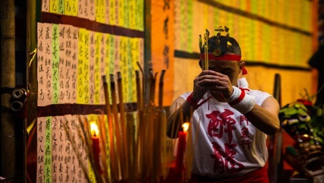 A performer prays before the Drunken Dragon celebration which is believed to bring prosperity and safety to the fishing community. A wooden dragon designed to dance for blessings is spread out on an incense burner table. The wooden dragon’s head and tail are each held by a pair of inebriated dragon players. AFP A performer prays before the Drunken Dragon celebration which is believed to bring prosperity and safety to the fishing community. A wooden dragon designed to dance for blessings is spread out on an incense burner table. The wooden dragon’s head and tail are each held by a pair of inebriated dragon players. AFP