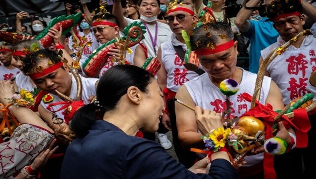 An official blesses a dragon at the beginning of the Drunken Dragon celebration. AFP An official blesses a dragon at the beginning of the Drunken Dragon celebration. AFP