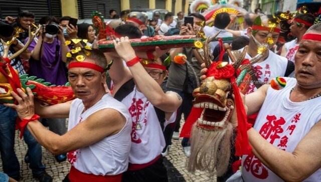 Performers dance through Leal Senado Square during the Drunken Dragon celebration. The dance itself is distinctive to China and involves performers lurching around the streets while sprinkling beer and rice wine from their mouths. AFP Performers dance through Leal Senado Square during the Drunken Dragon celebration. The dance itself is distinctive to China and involves performers lurching around the streets while sprinkling beer and rice wine from their mouths. AFP