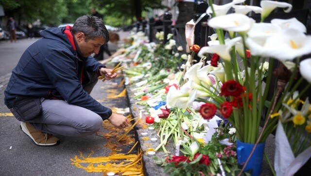 A man mourning the killing by lighting candles near the Serbian school, To help people deal with the tragedy, authorities announced they were setting up a helpline. Hundreds answered a call to donate blood for the wounded victims. A three-day mourning period will begin Friday morning. AP