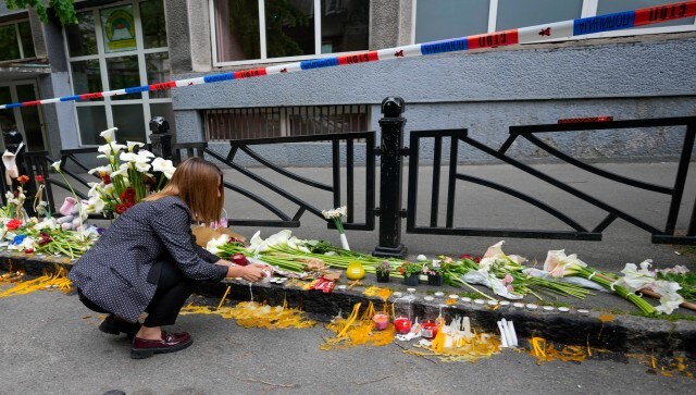 A woman lights candles for the victims near the Vladislav Ribnikar school. The shooting on Wednesday morning in Vladislav Ribnikar primary school also left seven people hospitalised — six children and a teacher. AP