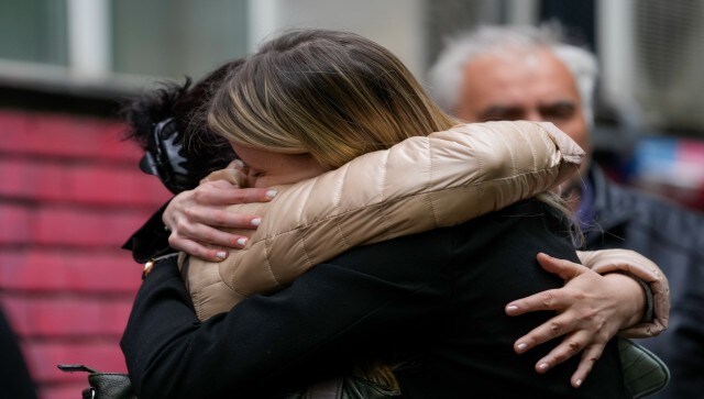 Many people cried and hugged outside the school as they stood in front of heaps of flowers, small teddy bears, a grey and pink toy elephant and a girl’s ballet shoes hung on the fence. AP