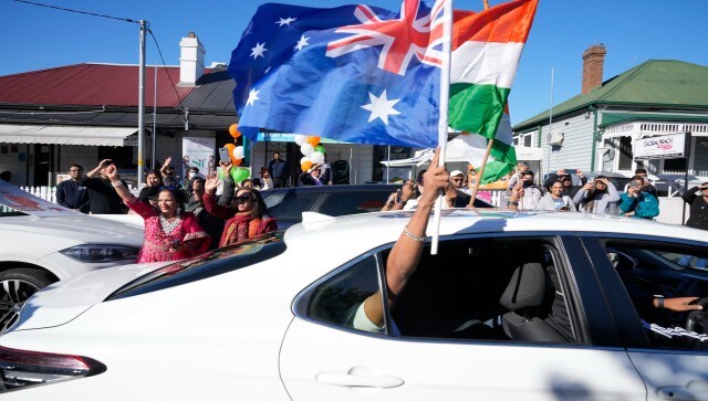 People dance in the street and wave Indian and Australian flags from cars as they wait hoping Indian Prime Minister Narendra Modi might visit the suburb of Harris Park in Sydney. AP People dance in the street and wave Indian and Australian flags from cars as they wait hoping Indian Prime Minister Narendra Modi might visit the suburb of Harris Park in Sydney. AP