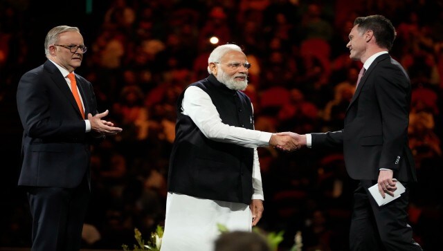 Prime Minister Narendra Modi (centre), shakes hands with New South Wales premier Chris Mines as Australian PM Anthony Albanese (left), looks on during the event at Qudos Bank Arena in Sydney. The prime minister said to the thousands in attendance, “Mutual trust and mutual respect have not developed only due to the diplomatic relations of India-Australia. The real reason, the real power is – all of you Indians who live in Australia.” AP Prime Minister Narendra Modi (centre), shakes hands with New South Wales premier Chris Mines as Australian PM Anthony Albanese (left), looks on during the event at Qudos Bank Arena in Sydney. The prime minister said to the thousands in attendance, “Mutual trust and mutual respect have not developed only due to the diplomatic relations of India-Australia. The real reason, the real power is – all of you Indians who live in Australia.” AP